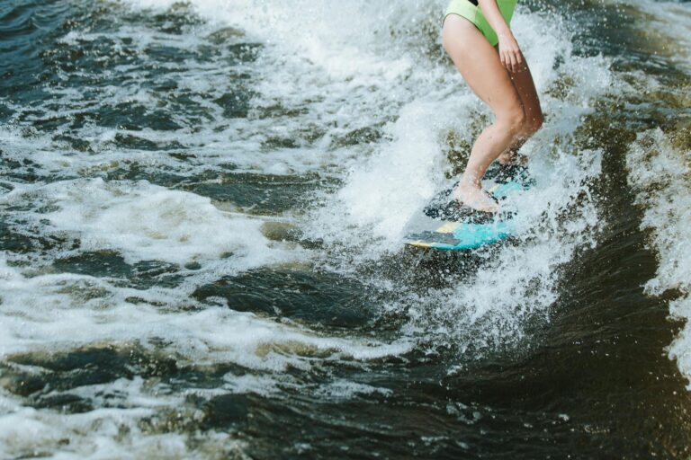 Catch the thrill of wakesurfing with this dynamic shot of a woman riding the waves.